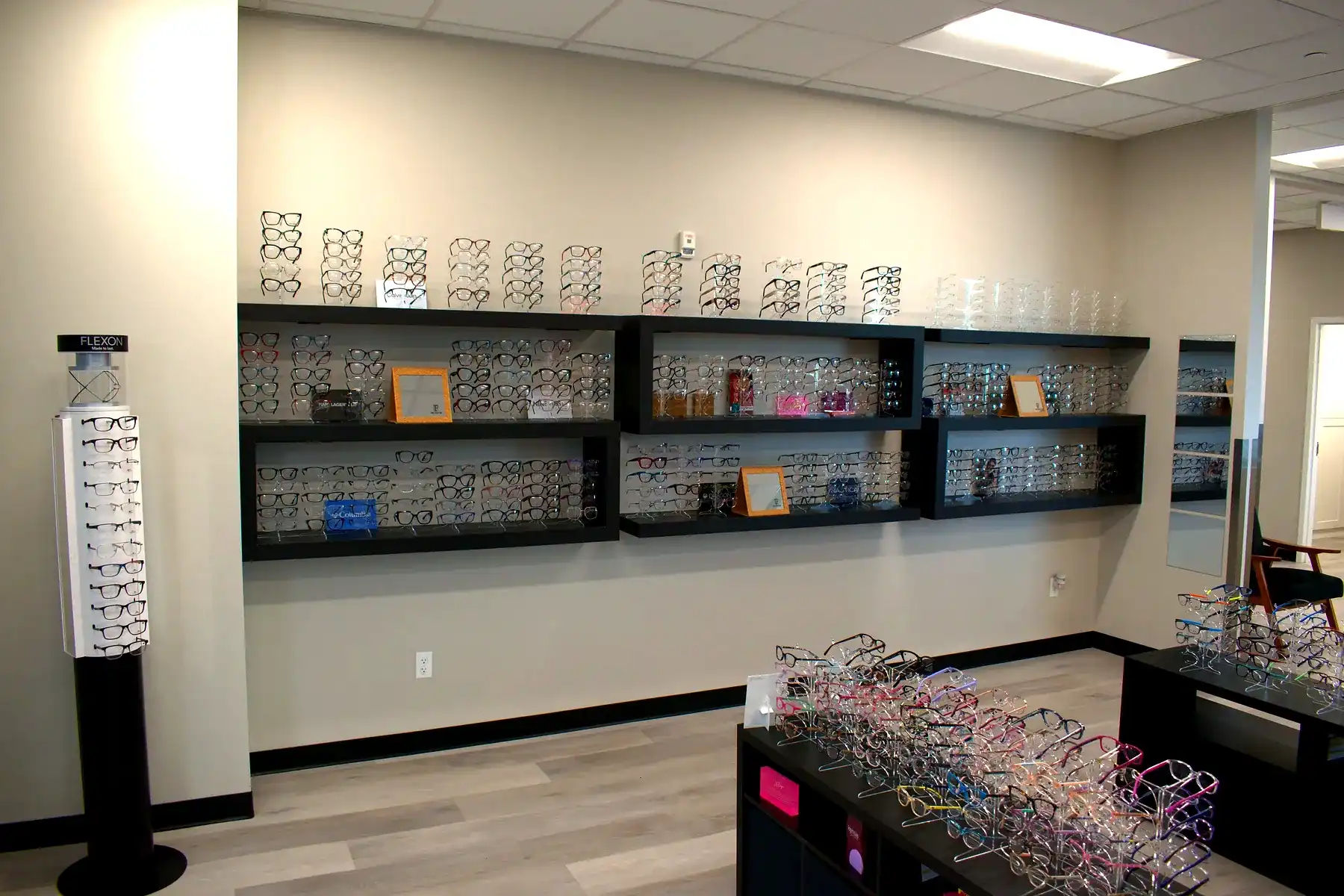 Family wearing glasses in an optical office